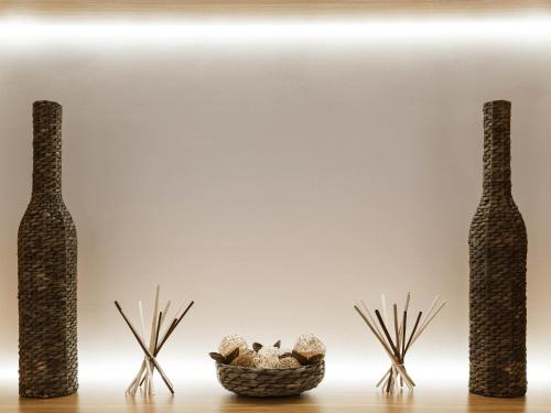 a table with two vases and a basket of mushrooms at Novotel Warszawa Airport in Warsaw