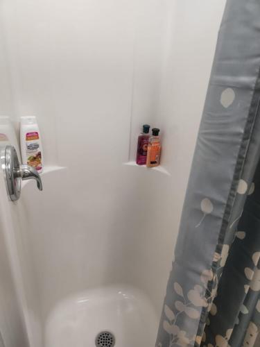 a bathroom with a shower curtain and a sink at Toronto Central Stay Living Bloor in Toronto