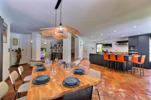 a dining room and kitchen with a large wooden table at Summer Gem - Nature & Swimming Pool in Ventabren