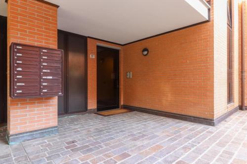 an empty hallway of a brick building with a door at La casetta in Castel Maggiore