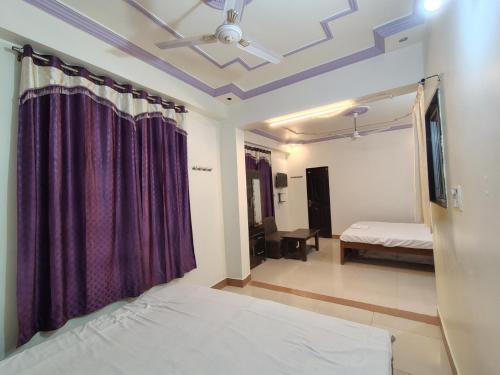 a bedroom with a bed and a ceiling at SN3 Hotel in Fatehpur City