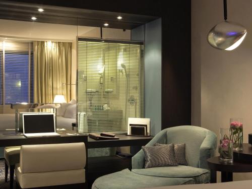 a room with a desk with a laptop and a chair at Sofitel Marseille Vieux-Port in Marseille