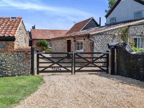 a wooden gate to a house with a stone wall at 3 Bed in Beeston 88223 in Beeston