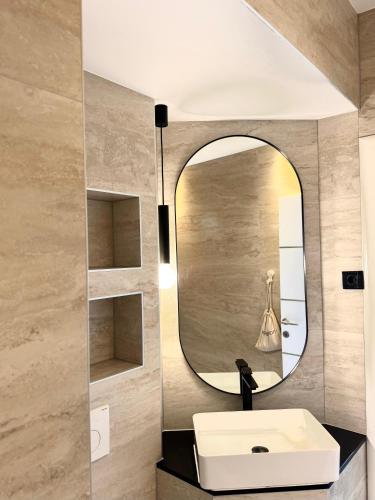 a bathroom with a sink and a mirror at Villa Knez in Trogir