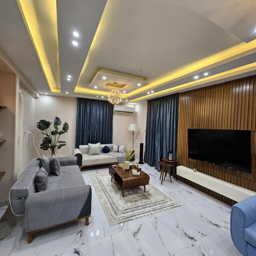 a living room with a couch and a television at اكتوبر in 6th Of October