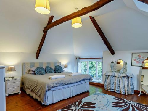 a bedroom with a bed with blue pillows on it at 4 Bed in Looe 47668 in Liskeard