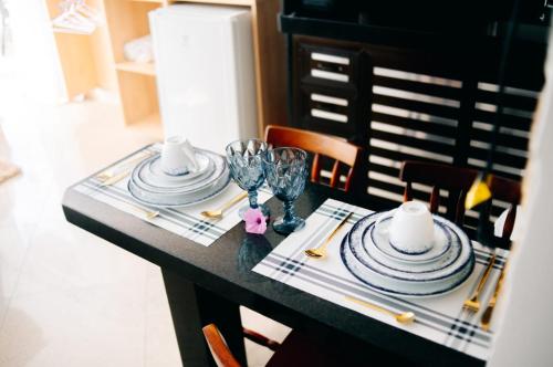 a table with plates and wine glasses on it at Canto da Canoa in Arraial do Cabo