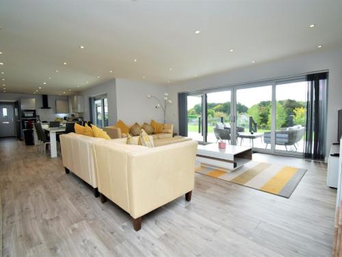 a living room with a white couch and a table at 4 Bed in Oswestry 75175 in Kinnerley