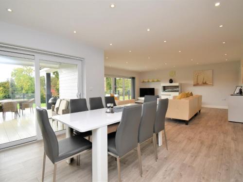 a dining room and living room with a table and chairs at 4 Bed in Oswestry 75175 in Kinnerley
