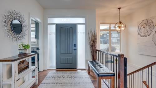 a hallway with a blue door and a bench at Hot Tub, Pool, City Views, close to Silver Star in Vernon