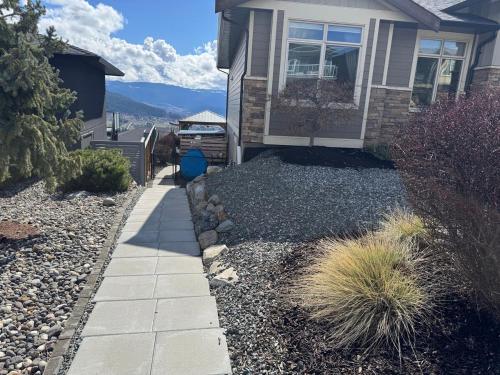a house with a walkway in front of a yard at Hot Tub, Pool, City Views, close to Silver Star in Vernon