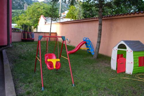 a yard with a playground with a swing at Комплекс Family Time Relax&Spa in Sliven