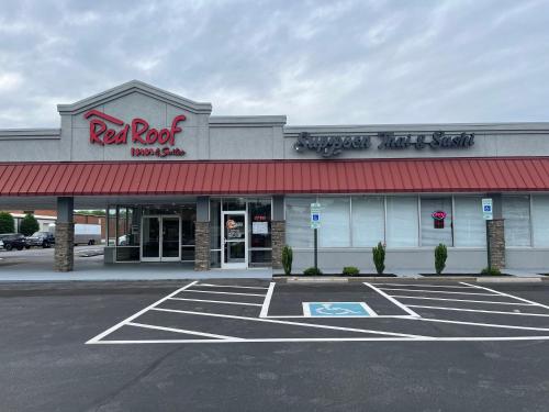 a store with a red roof and a parking lot at Red Roof Inn & Suites Wilkesboro in Wilkesboro