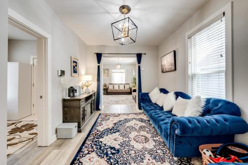 a living room with a blue couch and a rug at 1 Mi to Dtwn Elgin Dutch Colonial with Lovely Patio in Elgin