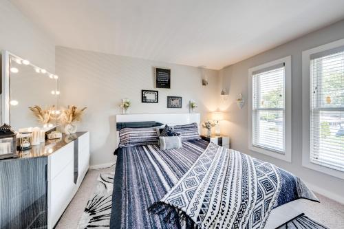 a bedroom with a bed and two windows at 1 Mi to Dtwn Elgin Dutch Colonial with Lovely Patio in Elgin