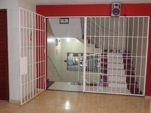 a dog in a cage in a hospital at Antares Inn in Lima