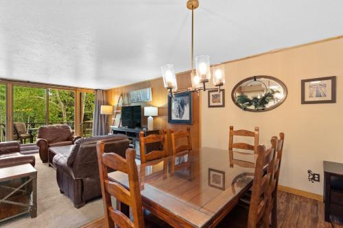 a dining room and living room with a table and chairs at Lodgepole 2003 by Summit County Mountain Retreats in Keystone