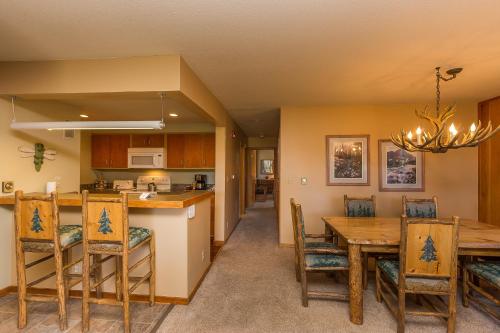 a kitchen and dining room with a table and chairs at Pines 2166 by Summit County Mountain Retreats in Keystone