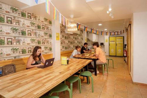 a group of people sitting at a table in a restaurant at Onefam Batlló in Barcelona