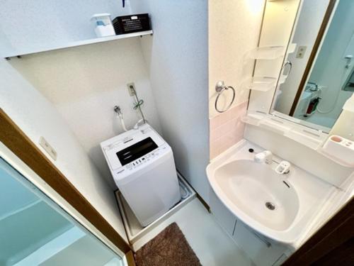 a small bathroom with a toilet and a sink at Blue Eyes Chuo - Vacation STAY 16693 in Kagoshima