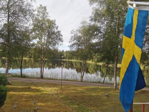 a flag with a view of a lake at 4 person holiday home in Brålanda in Brålanda