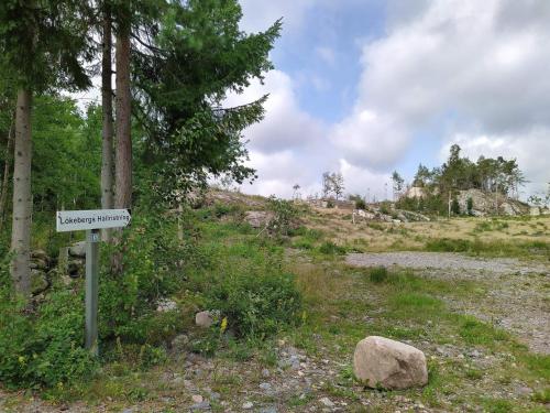 a sign on the side of a dirt road at 5 person holiday home in MUNKEDAL-By Traum in Munkedal
