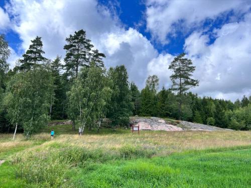 a person in a field with trees in the background at 5 person holiday home in MUNKEDAL-By Traum in Munkedal