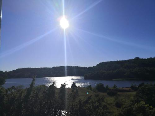a view of a lake with the sun in the sky at 5 person holiday home in MUNKEDAL-By Traum in Munkedal