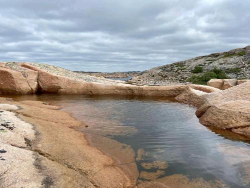 a body of water on the side of a mountain at 4 star holiday home in Hamburgsund in Hamburgsund