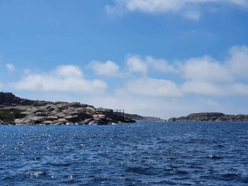 a large body of water with rocks in the distance at 4 star holiday home in Hamburgsund in Hamburgsund