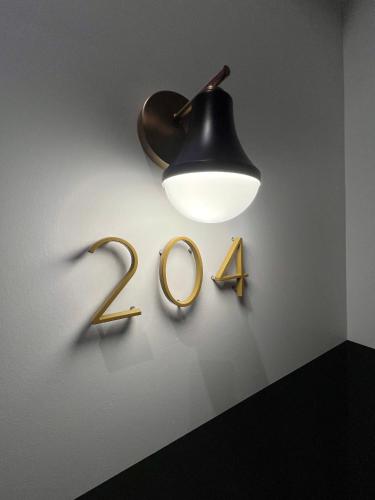 aendant light and two rings on a wall at The Produce Suites in Toledo