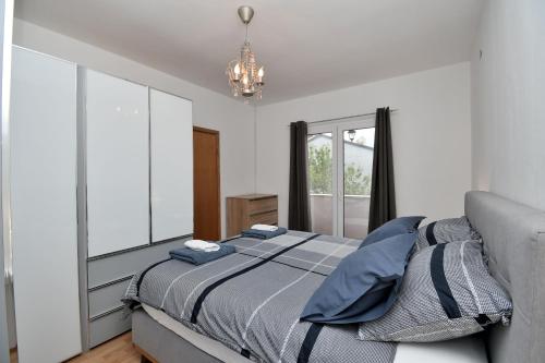 a bedroom with a bed and a large window at House Villa Lili in Žminj