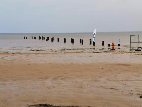 an empty beach with a pier in the water at Nice apartment near the beach-By Traum in Mellbystrand