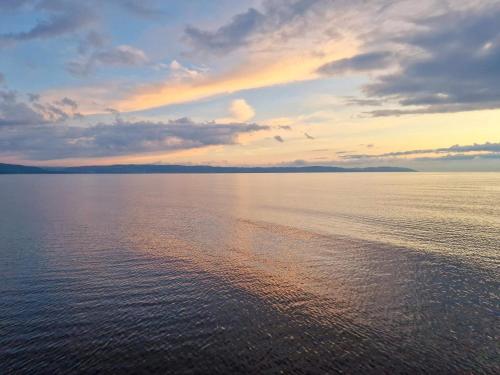 a sunset over a large body of water at Nice apartment near the beach-By Traum in Mellbystrand