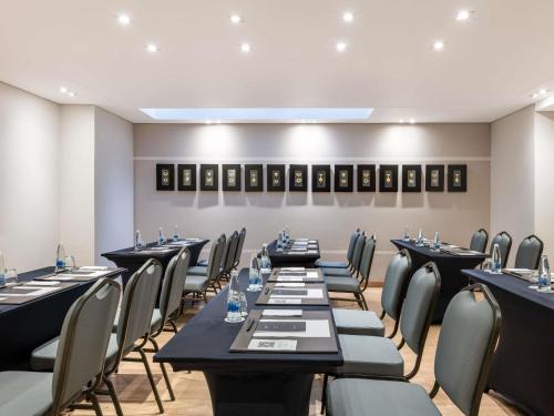 a restaurant with long tables and chairs in a room at Sofitel Bogota Victoria Regia in Bogotá