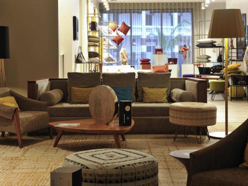 a living room with couches and a table in a store at Pullman Dakar Teranga in Dakar