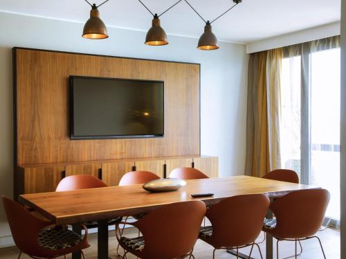 a conference room with a wooden table and chairs at Pullman Dakar Teranga in Dakar