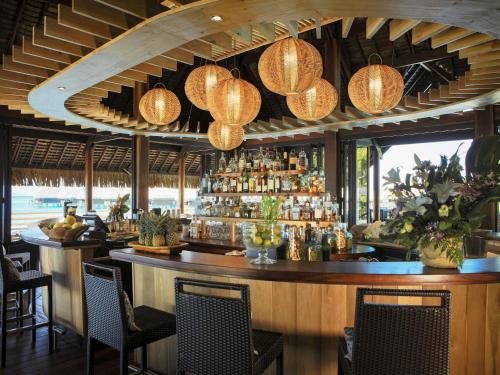a bar in a resort with a bar counter at Sofitel Kia Ora Moorea Beach Resort in Maharepa