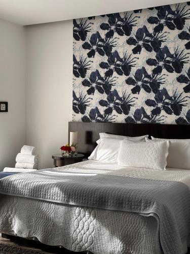 a bedroom with a large bed with a floral wallpaper at Al Natural Posada in Nueva Palmira