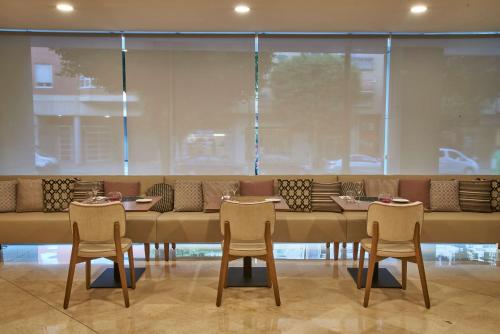 a dining room with a long table and chairs at NH Ciudad de Valencia in Valencia