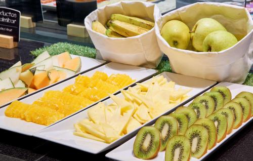 a display of different types of cheese and fruit at NH Ciudad de Valencia in Valencia