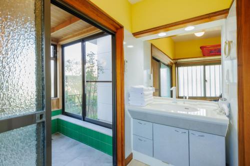 a bathroom with a sink and a window at -IRAKA- - Vacation STAY 19152 in Shiroishi