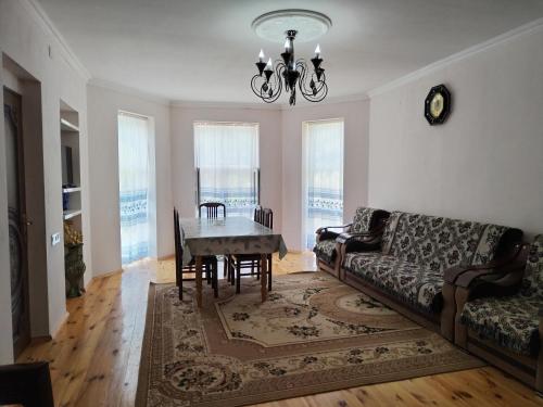 a living room with a table and a couch at Shahdag Touch the clouds in Qusar