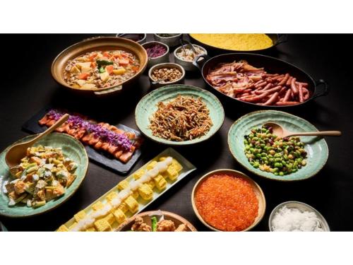 a table topped with bowls of different types of food at Skye Niseko - Vacation STAY 70602v in Niseko