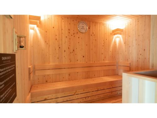 a wooden sauna with a clock on the wall at Skye Niseko - Vacation STAY 70597v in Niseko