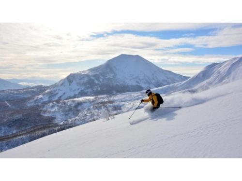 a person is skiing down a snow covered mountain at Skye Niseko - Vacation STAY 70597v in Niseko