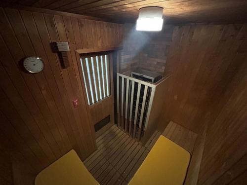 an overhead view of a room with yellow chairs and a clock at Hotel Tetora Hachinohe - Vacation STAY 12756v in Hitoichi