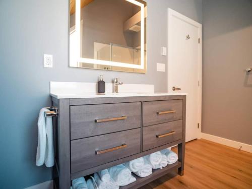 a bathroom with a vanity with a sink and a mirror at Pur Lodging Mountain Cabin 1 - Private Hot Tub in Golden