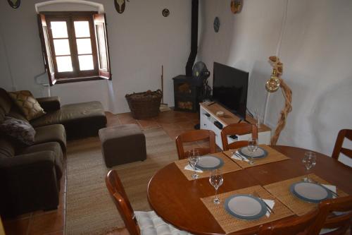 a living room with a wooden table and a couch at Casa do Chico in Mértola