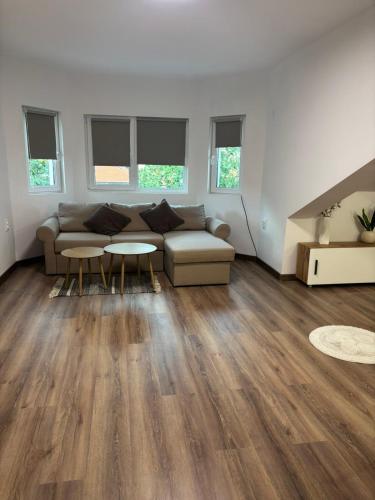 a living room with a couch and a table at White House Apartments - Studio Lux in Haskovo